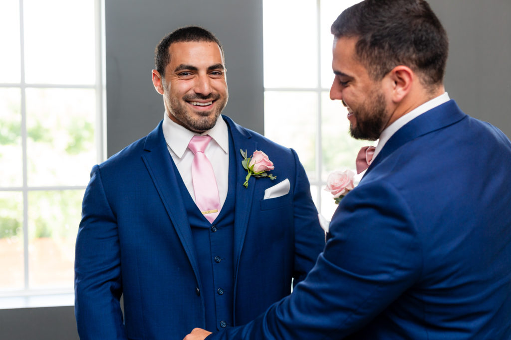 Smiling groom and best man before wedding