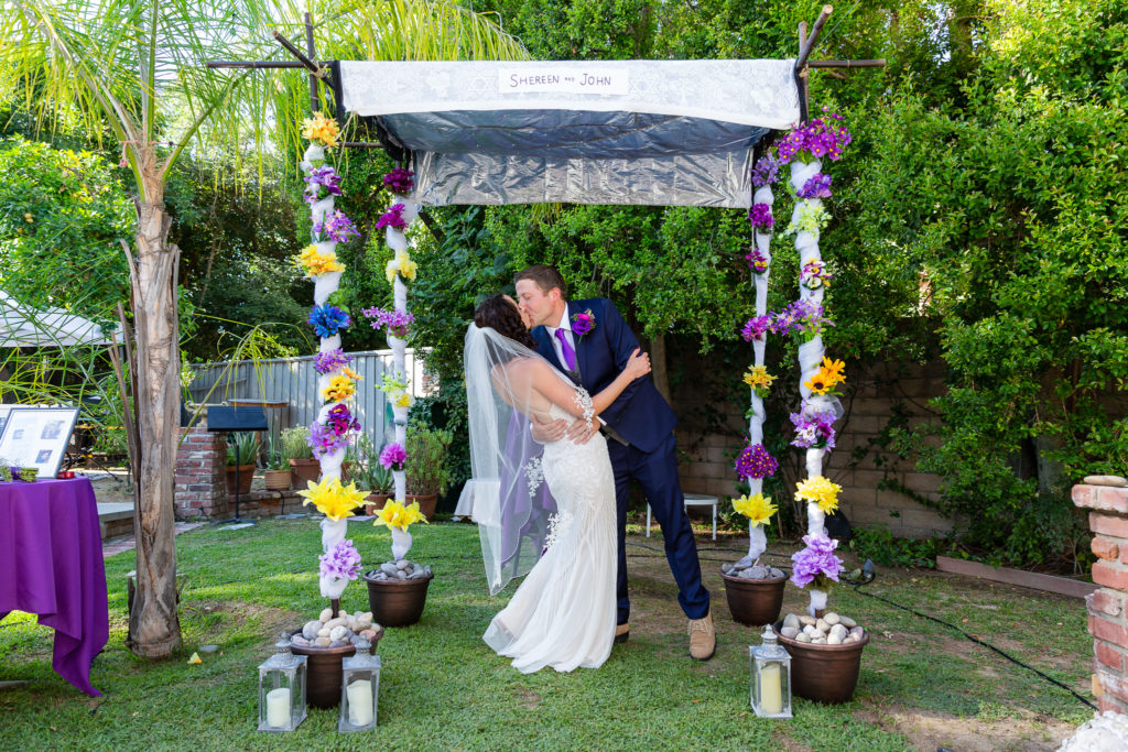 Wedding couple kissing during Intimate Backyard Wedding