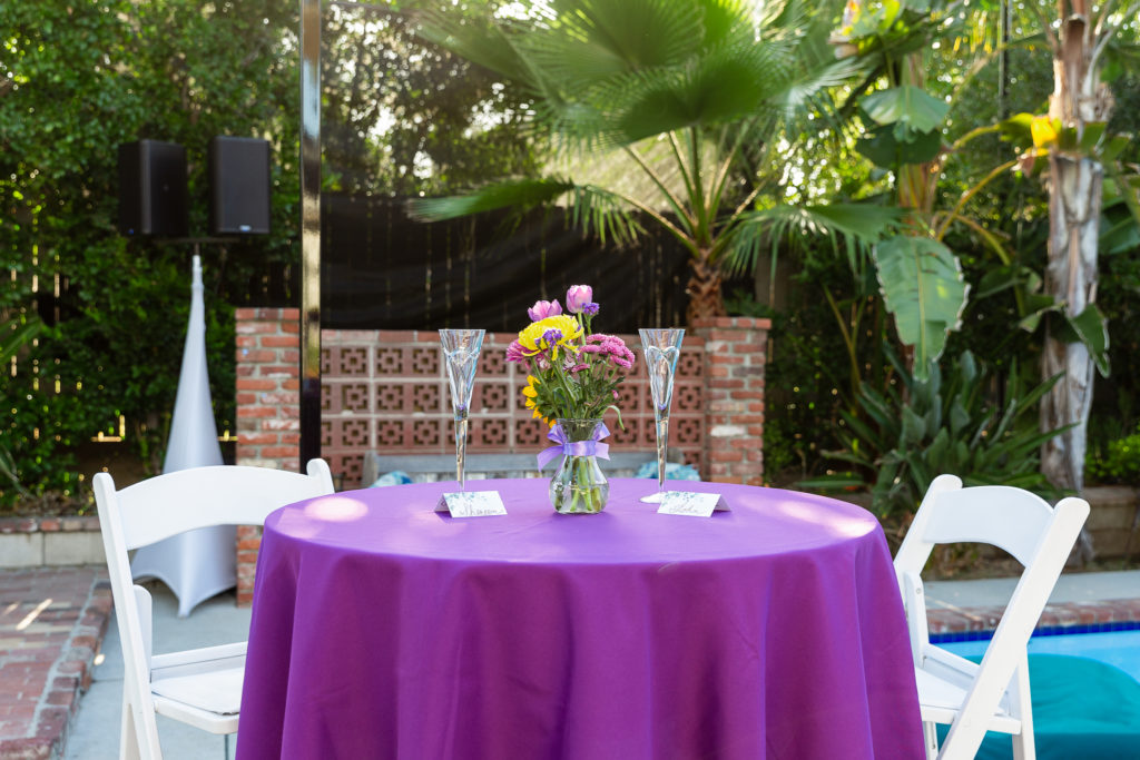 wedding couple table with purple table cloth