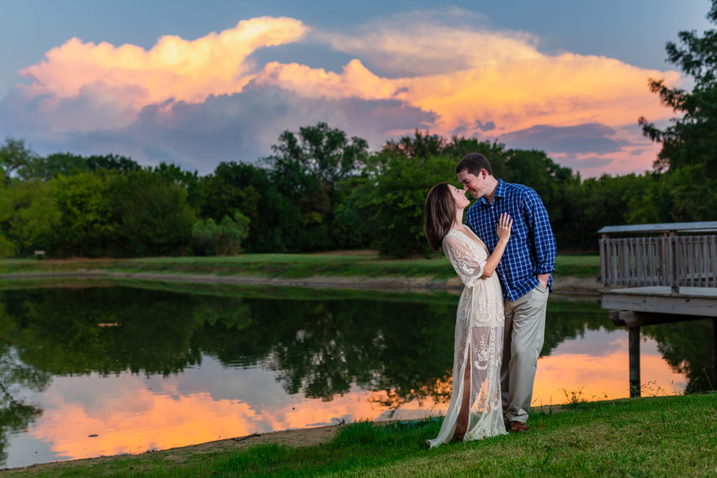 engagment session on a lake with bride and groom embracing with man leaning into the woman romantically including Tips to Help You Plan Your Engagement Session