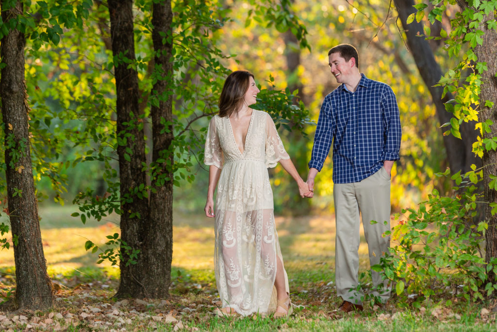 Couple holding hands in Colleyville Nature Center during engagement photoshoot