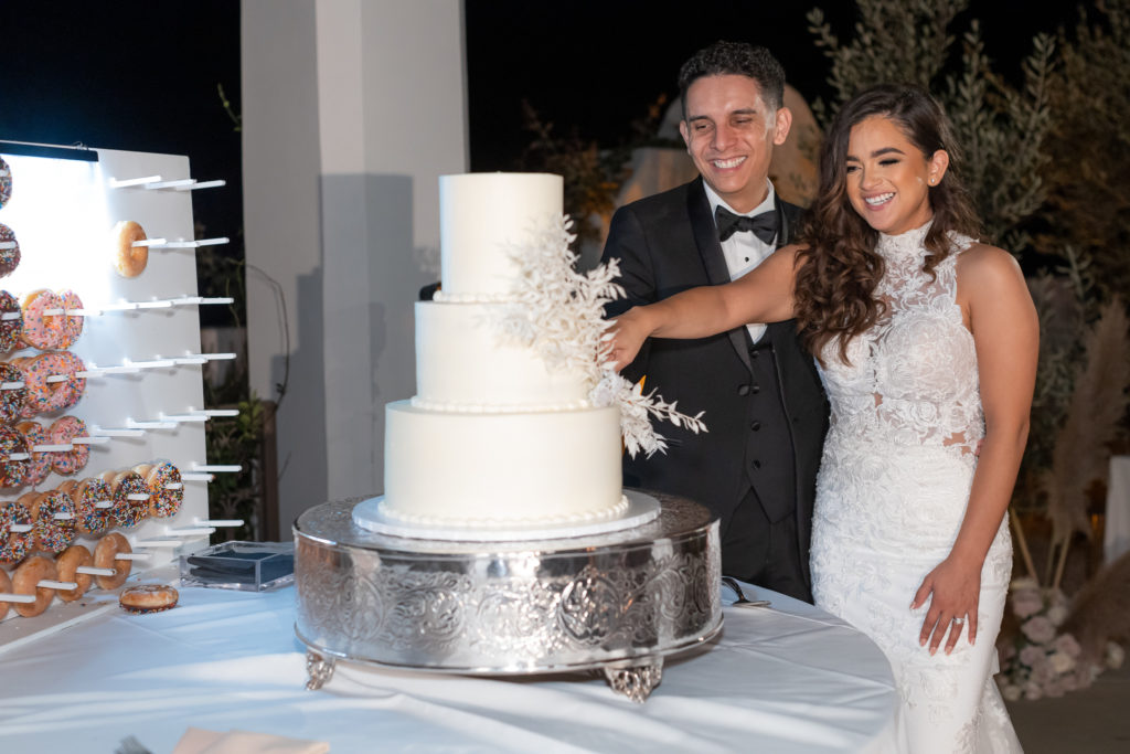 Malibu Estate Wedding bride and groom cutting wedding cake