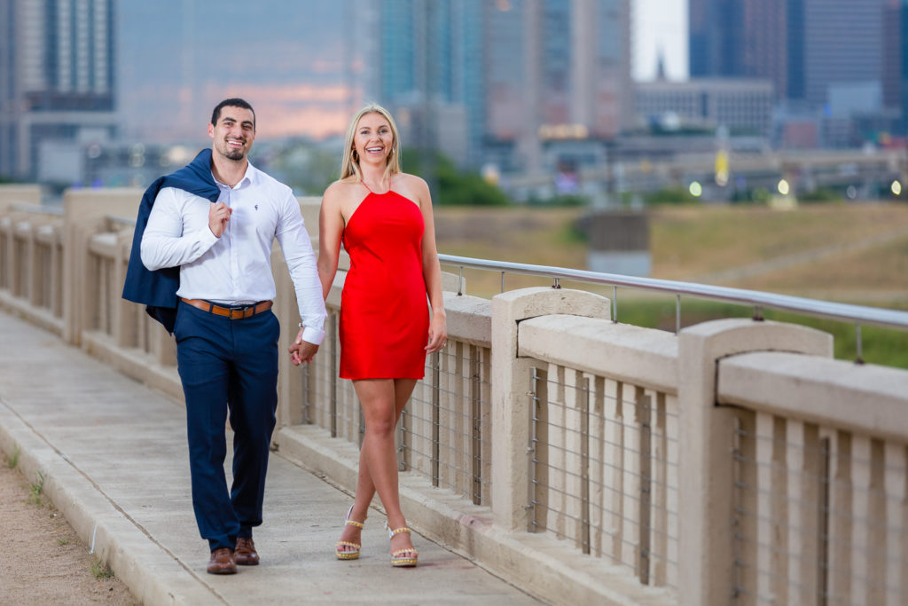Man in blue suit and woman in red dress during photoshoot