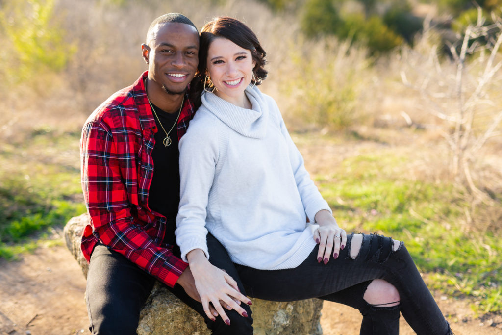 Couple sitting on a rock during photo session
