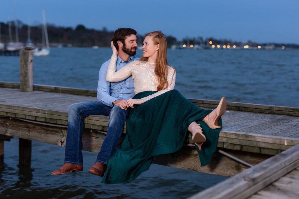 Couple sitting on dock during photoshoot