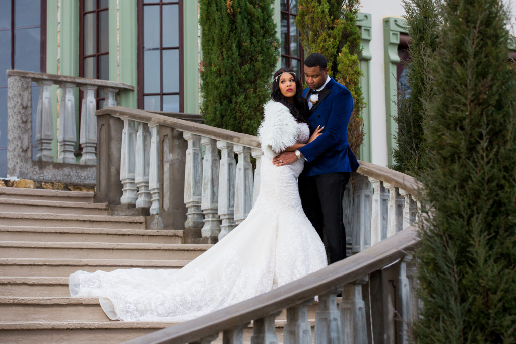 Bride and groom posing on stairs