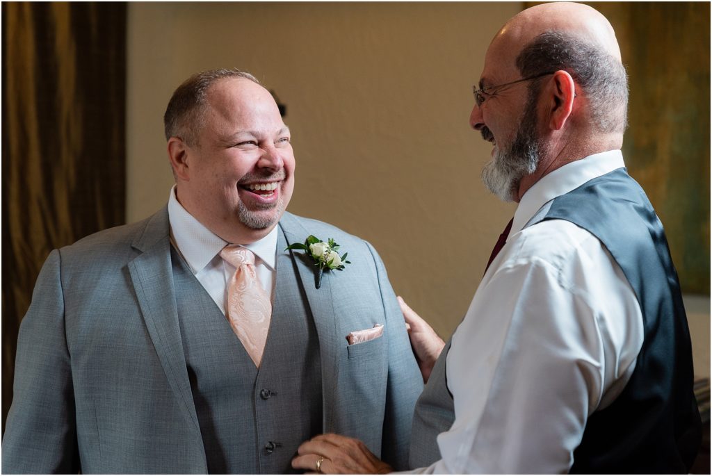 Dallas wedding photographers capture a joking moment between groom Chris and a groomsman