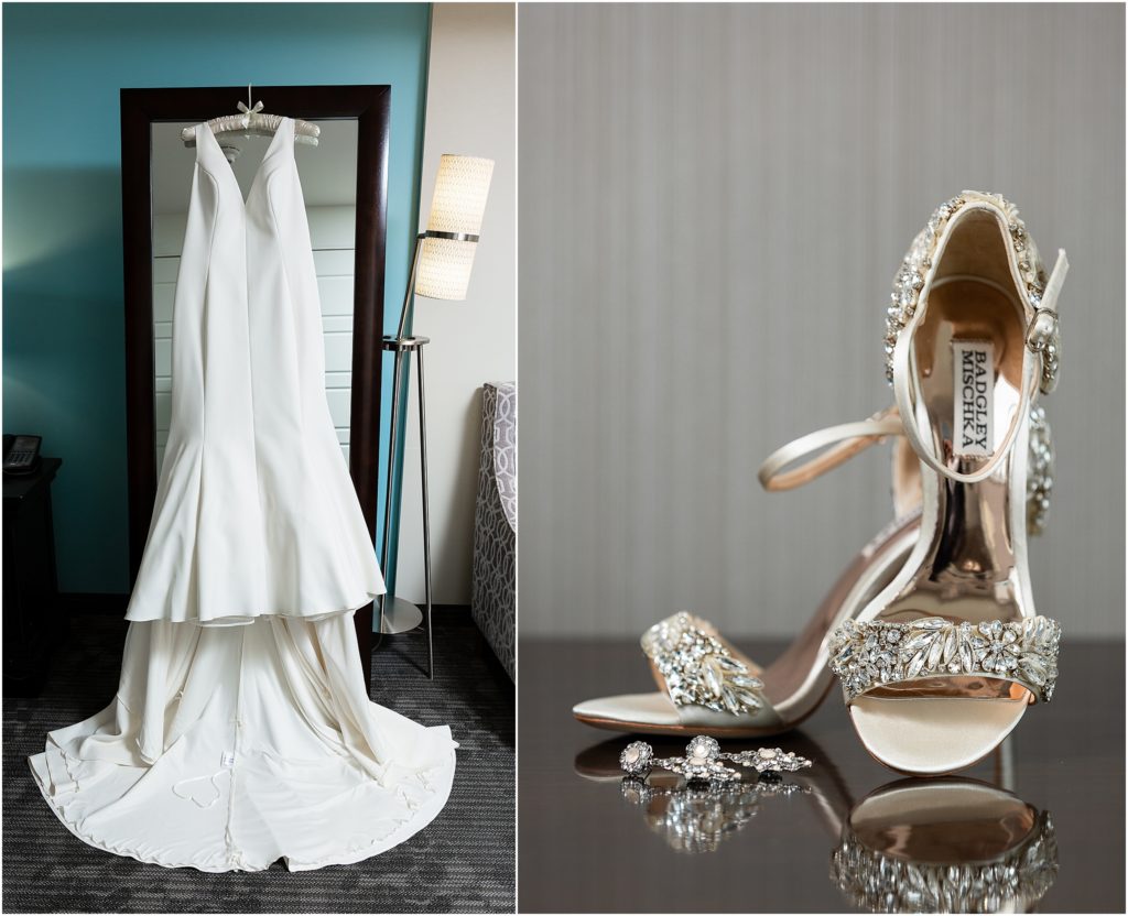 The bride's gown hangs on a black hanger on the left, the bride's gem encrusted Badgley Mischka shoes are set up on the right captured by Dallas wedding photographers