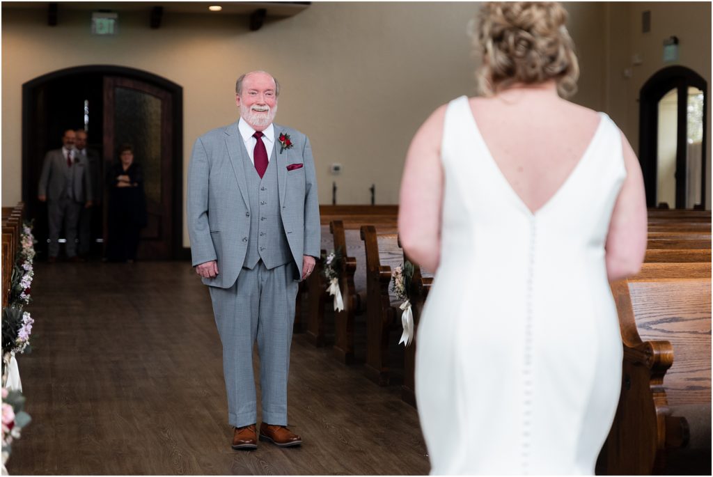 The father of the bride stands in shock looking at the bride during their first look at Ana Villa wedding venue captured by Dallas wedding photographers