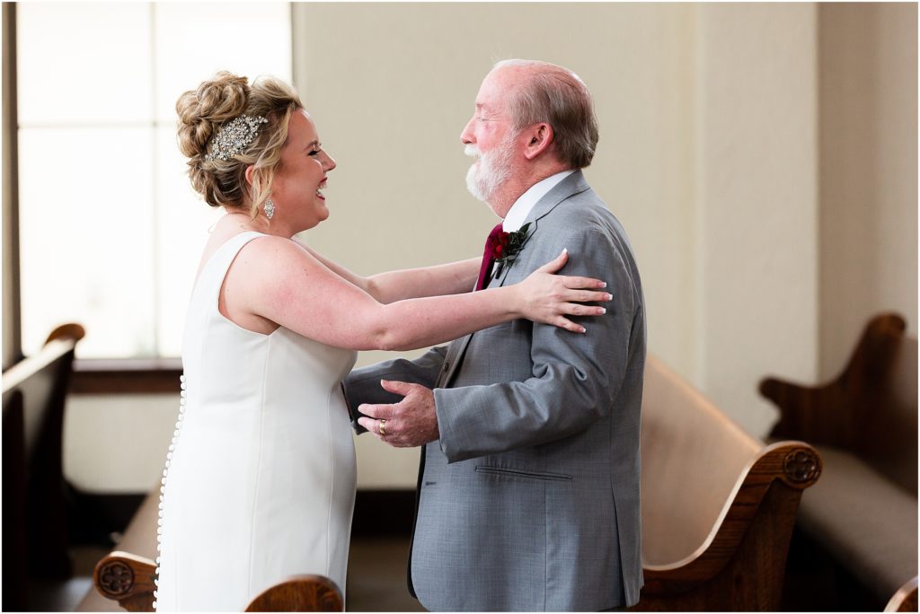 Dallas wedding photographer shoots a moment between bride and father of the bride as she stretches out her arms to embrace him