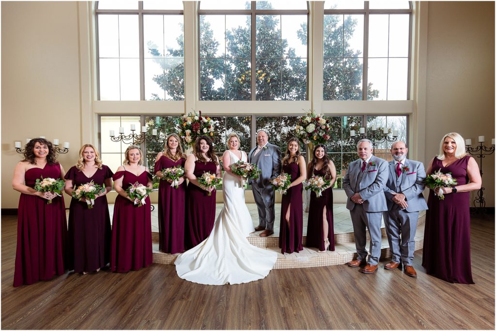 bridal party in red and grey at chapel at ana villa the colony tx captured by Dallas wedding photographers