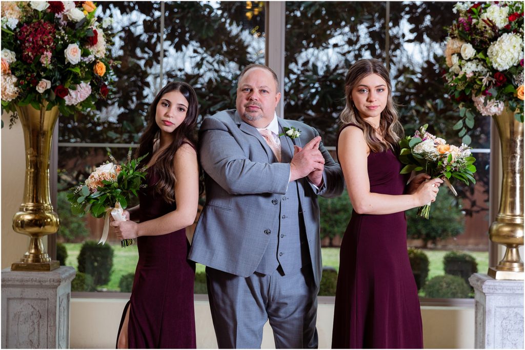 Groom and two daughters pose like Charlie's Angels for portrait taken by Dallas wedding photographers