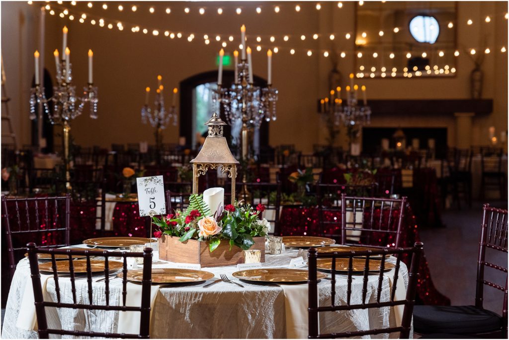 beautiful red themed ballroom with lanterns and twinkle lights at chapel ana villa in dallas texas photographed by Dallas wedding photographers