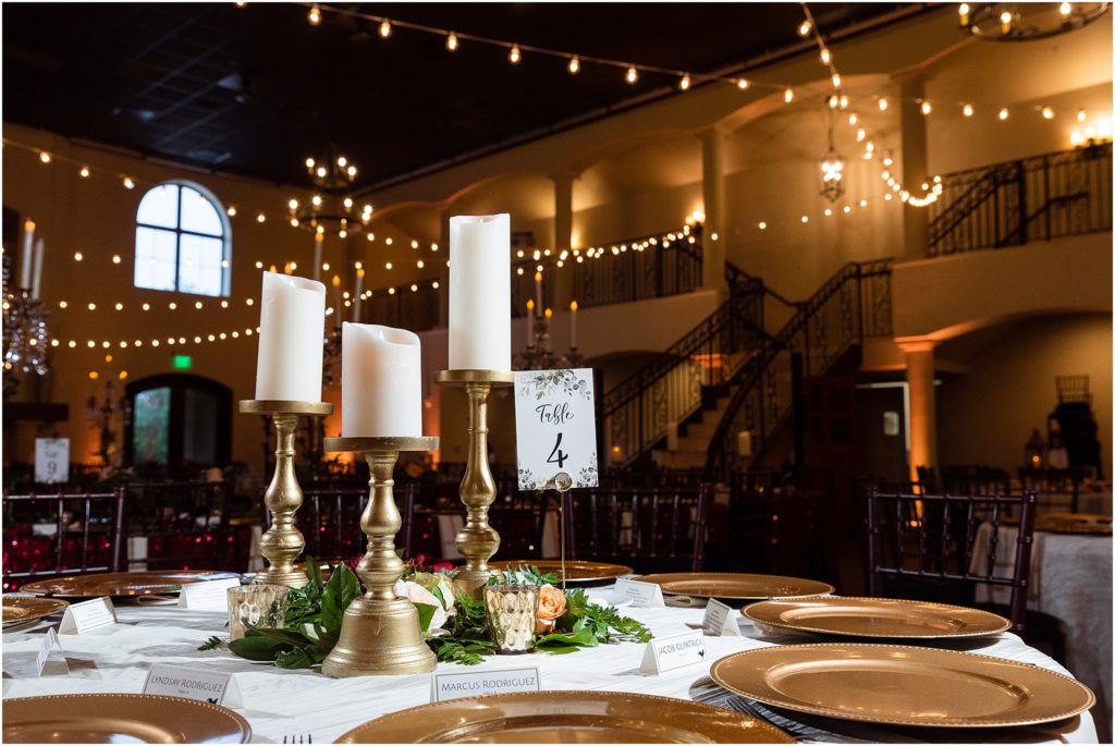 Table #4 set with white candles on gold pedestals photographed by Dallas wedding photographers
