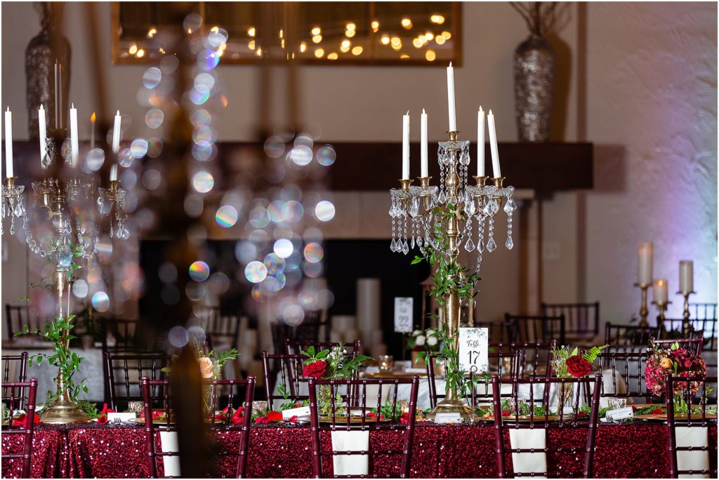A candelabra with dripping gems decorates table 17 at luxury wedding venue photographed by dallas wedding photographers