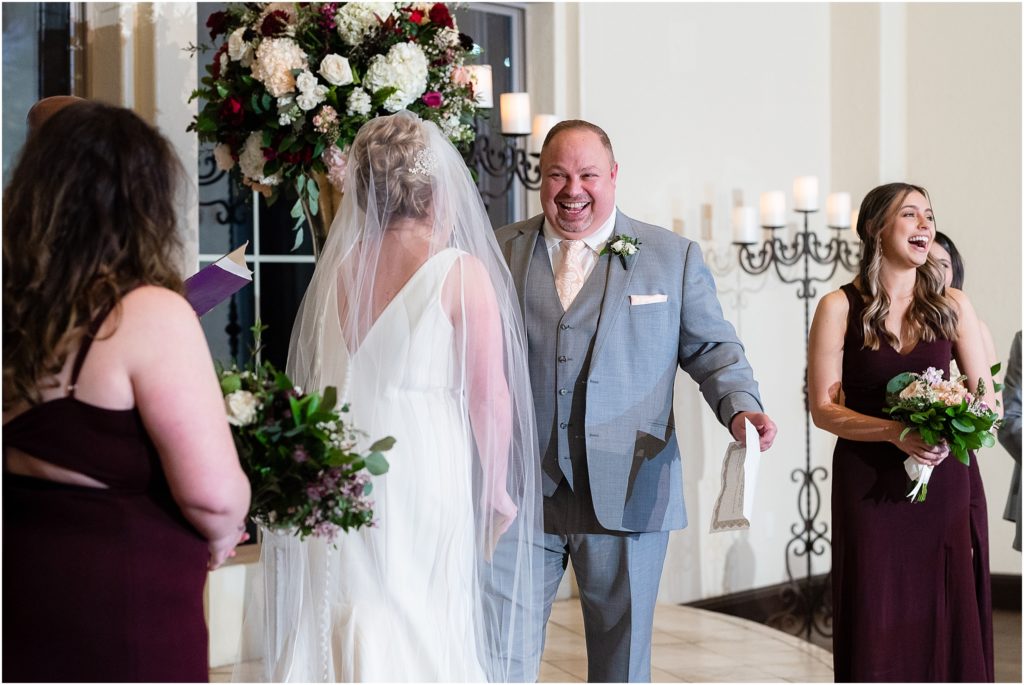 Groom jokes and bridesmaids laugh during vows at Ana Villa wedding ceremony photographed by Dallas wedding photographers