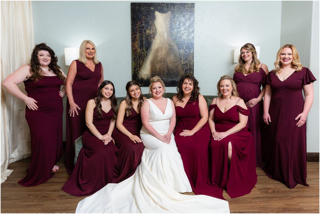 Dallas wedding photographers capture the bride and bridesmaids sitting on couch in bridal suite at chapel at ana villa wedding venue