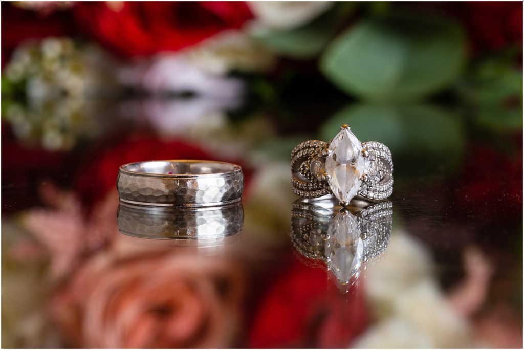 engagement ring and wedding band with flowers captured by Dallas wedding photographer