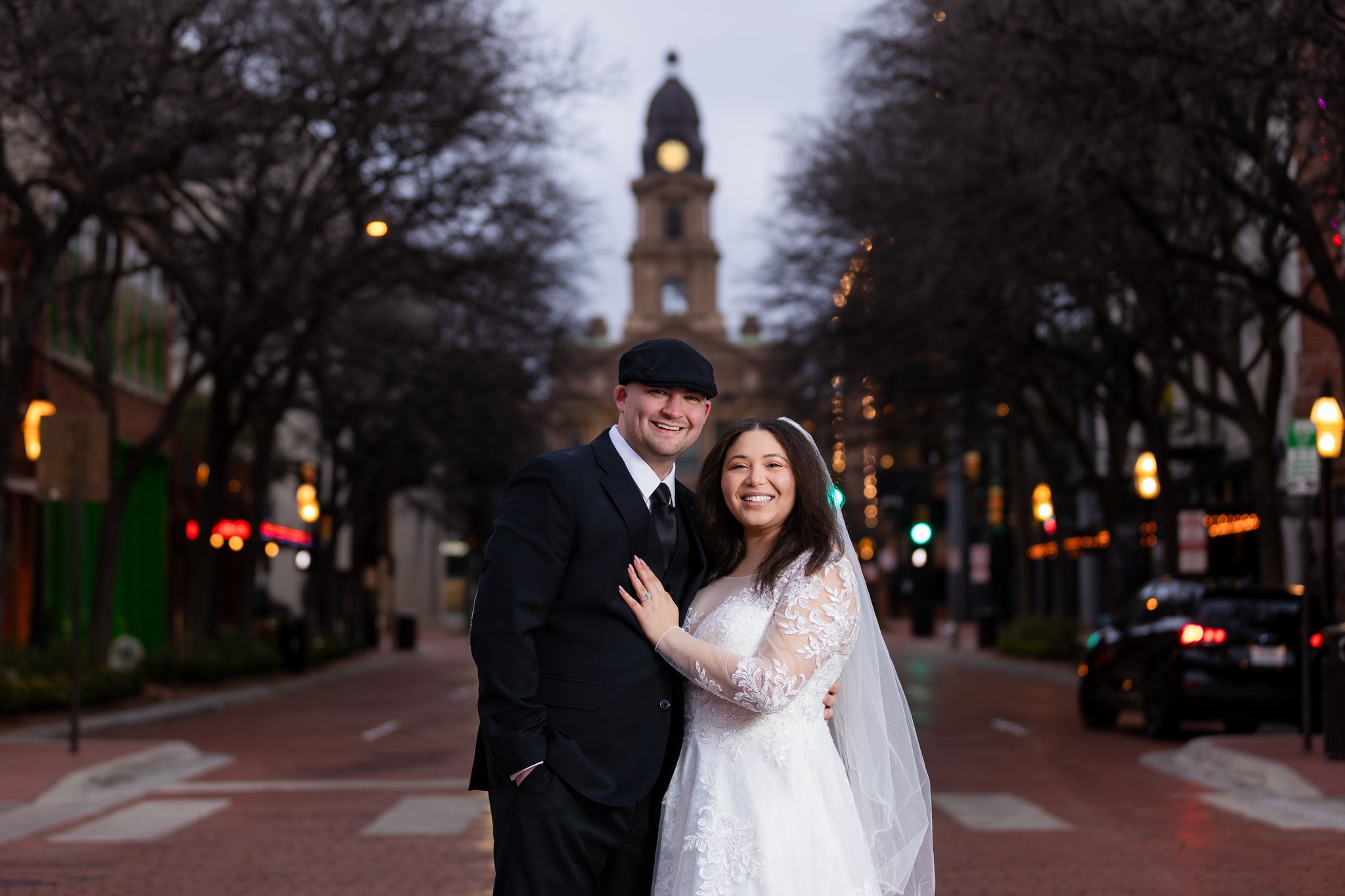 Wedding couple smiling in downtown Fort Worth with the Tarrant County Courthouse in background