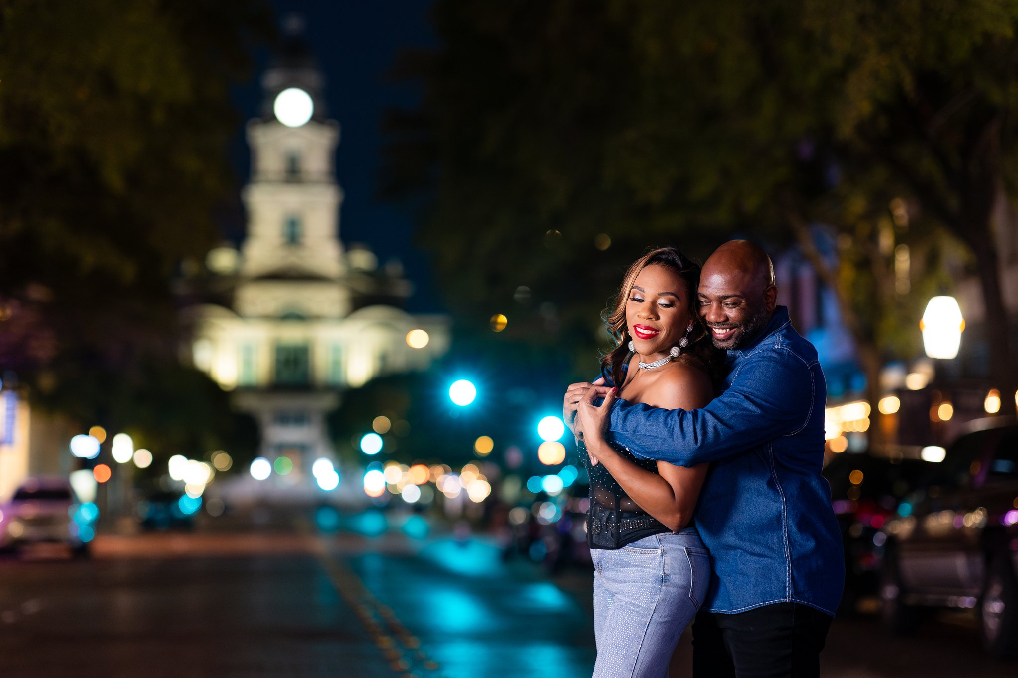 Couple hugging intimately in Sundance Square in downtown Fort Worth during engagement session