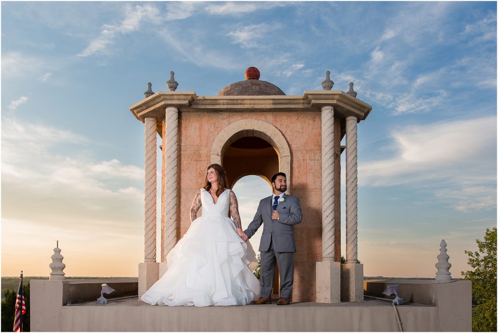 Bride and Groom holding hands on Stoney Ridge Villa rooftop during wedding photographed by Dallas wedding photographers
