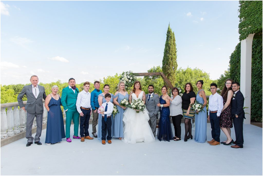 bride and groom standing with their families in their wedding space photographed by Dallas wedding photographers