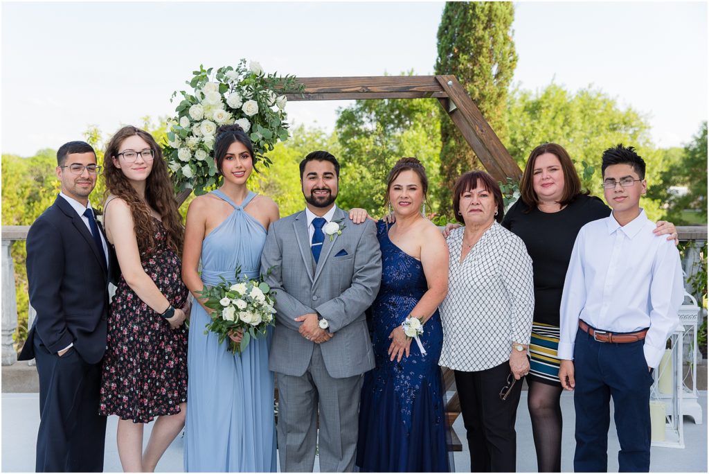 Dallas wedding photographers captures groom with his mother and siblings for family pictures during the wedding