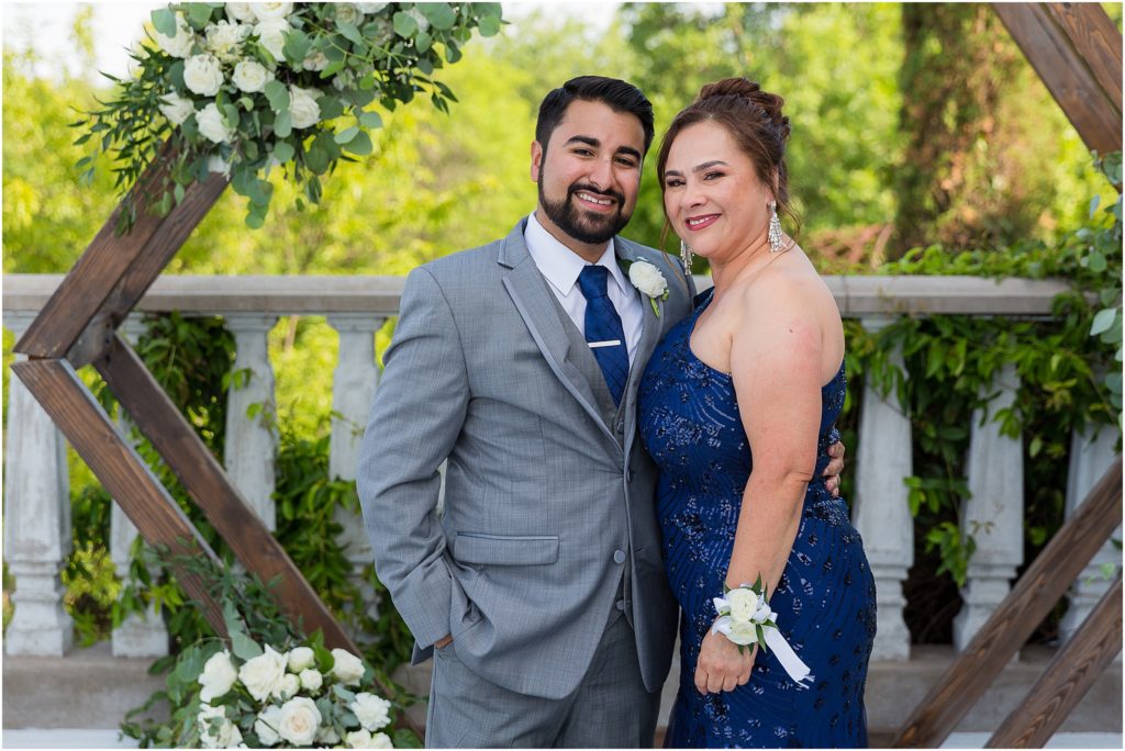 mother of the groom and groom standing together and smiling after the wedding ceremony captured by Dallas wedding photographers