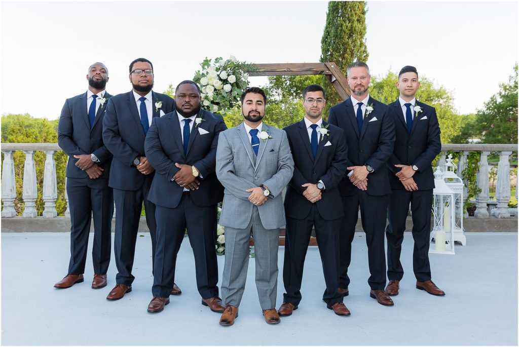 groom and groomsmen in grey and black suits photographed by Dallas wedding photographers