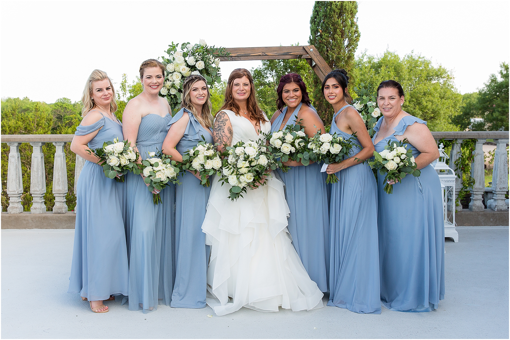bride and bridesmaids in dusty blue dresses