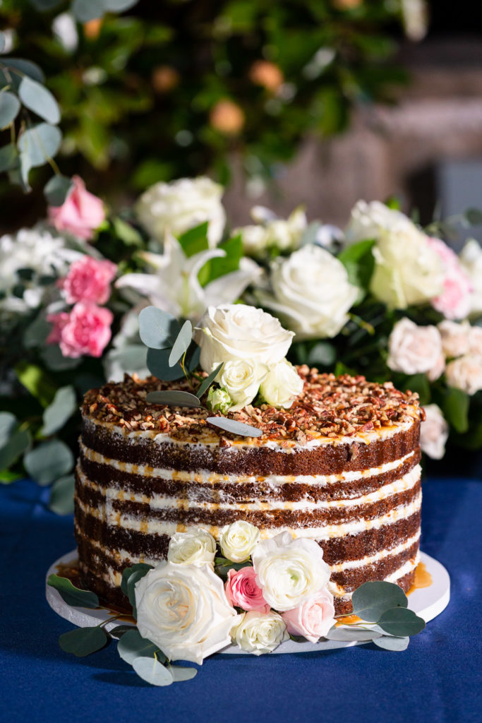 layered chocolate wedding cake with a simple rose on top for a Granbury wedding photographed by Dallas wedding photographer