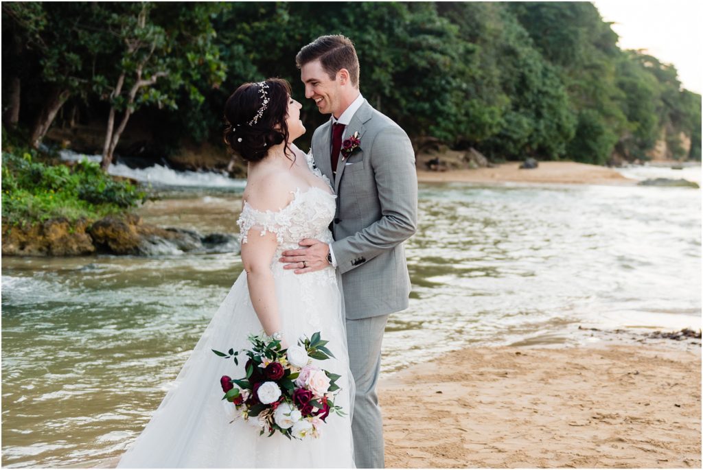 dallas wedding photographer captures bride and groom embracing for their destination wedding in the islands with groom holding his brides waist