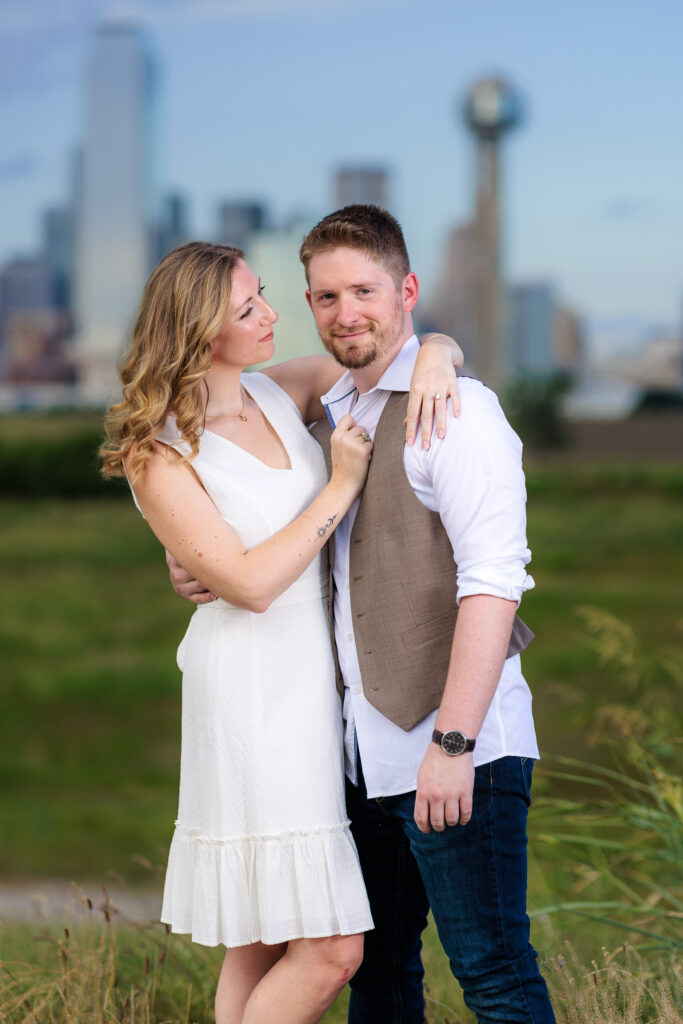 Dallas wedding photographers capture woman hugging fiance and looking over lovingly