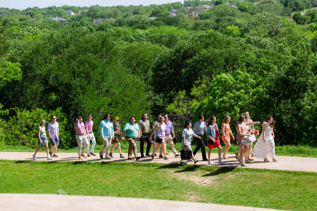 Dallas wedding photographers capture group of people walking together at Arbor Hills Nature Preserve