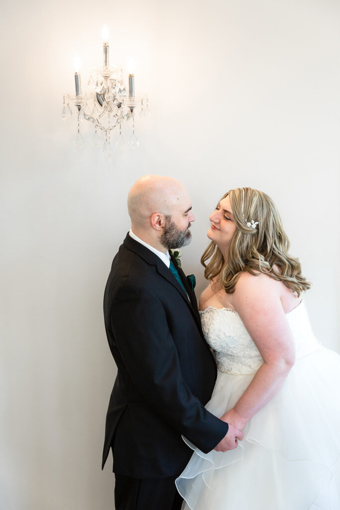 Bride and groom look lovingly at each other at Milestone Denton