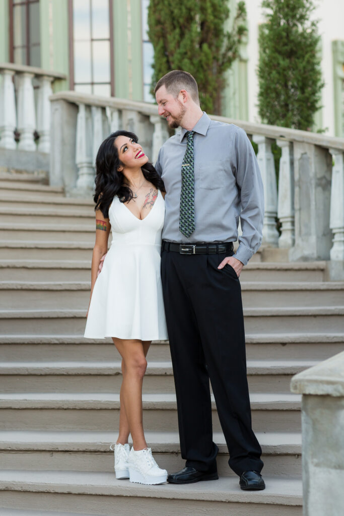 Dallas wedding photographers capture couple standing on staircase looking at one another