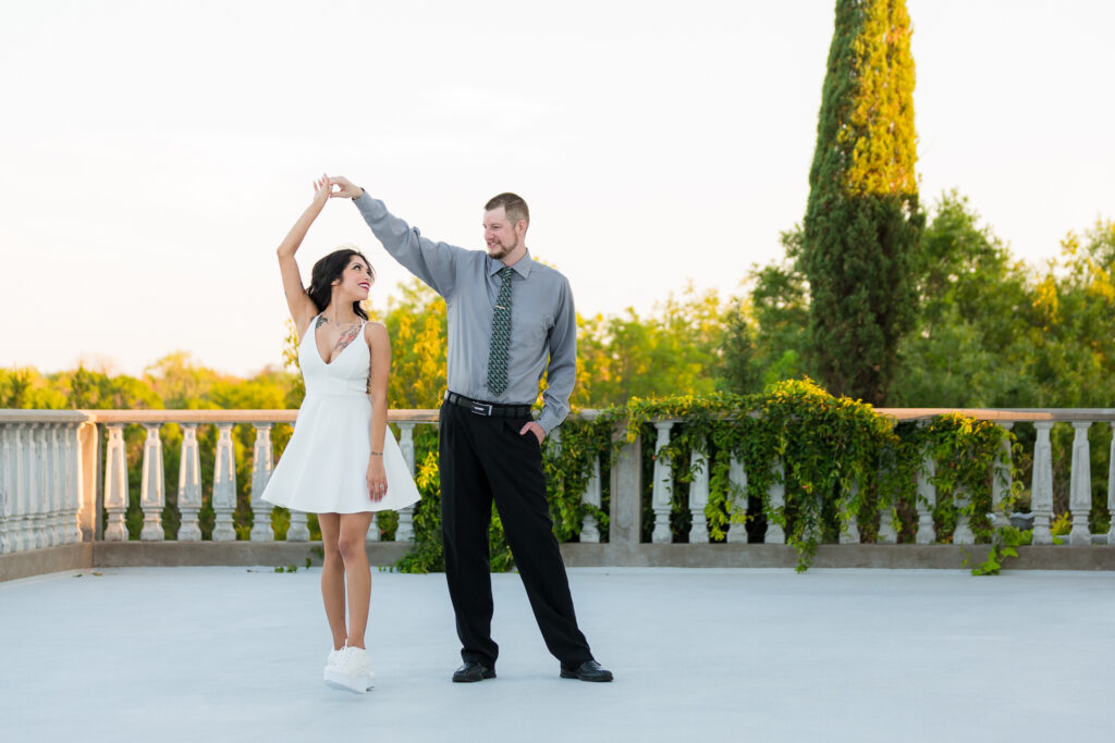 Dallas wedding photographers captures man spinning woman during outdoor engagements