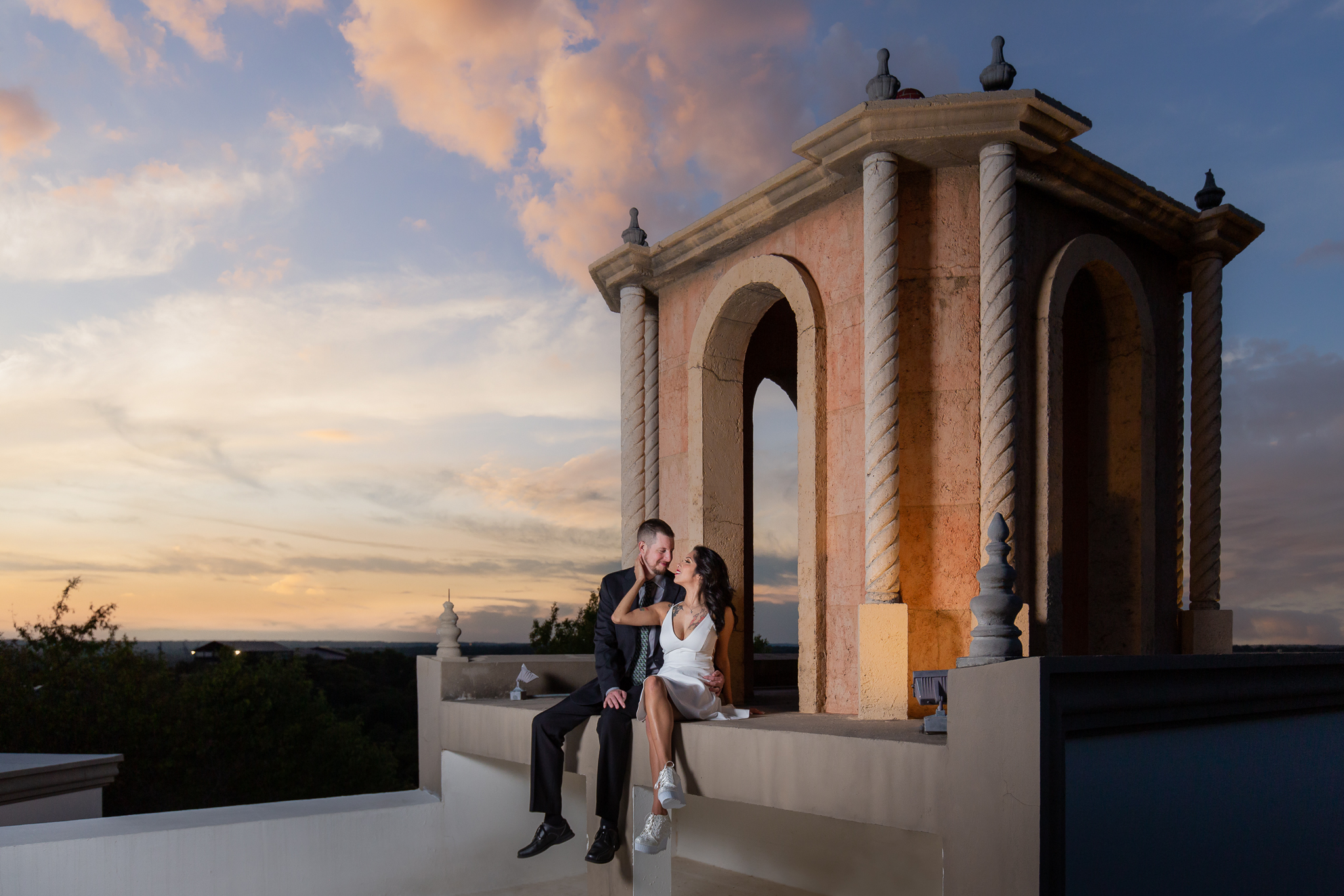 Dallas wedding photographers captures man and woman on roof during sunset