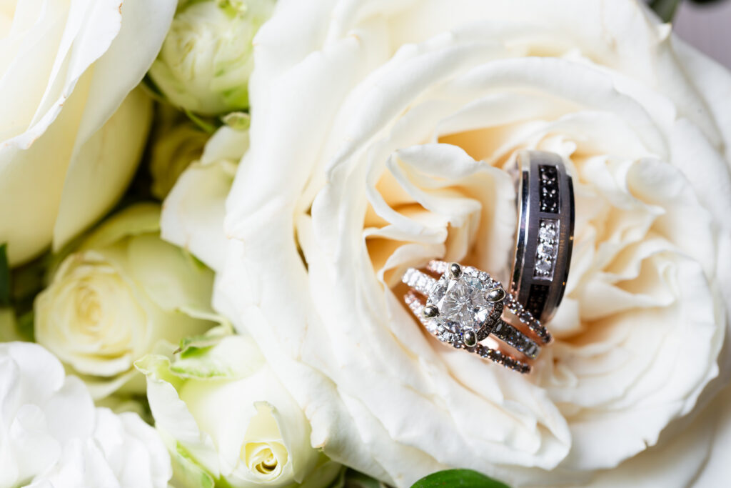 Dallas wedding photographers capture flowers with wedding rings sitting inside at Knotting Hill Place