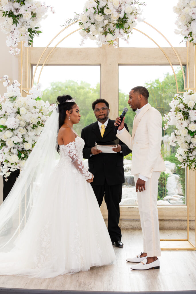 Dallas wedding photographers capture bride and groom during indoor wedding ceremony at Knotting Hill Place