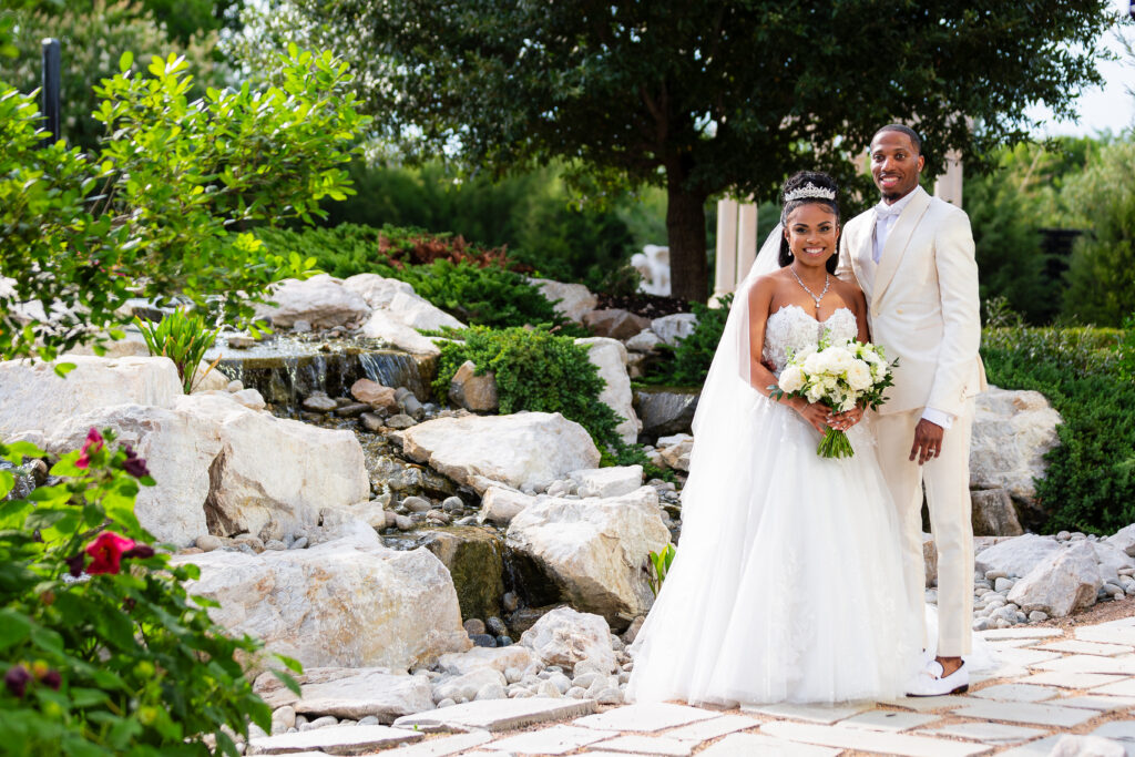 Dallas wedding photographers capture bride and groom wearing all white wedding attire at Knotting Hill Place wedding