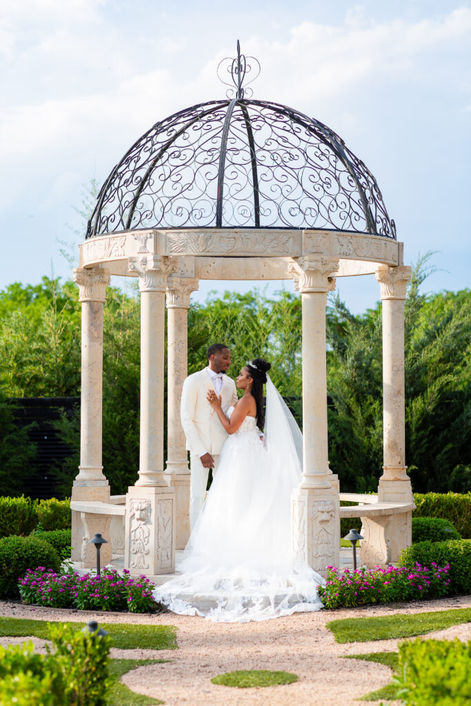 Dallas wedding photographers capture bride and groom in gazebo at Knotting Hill Place