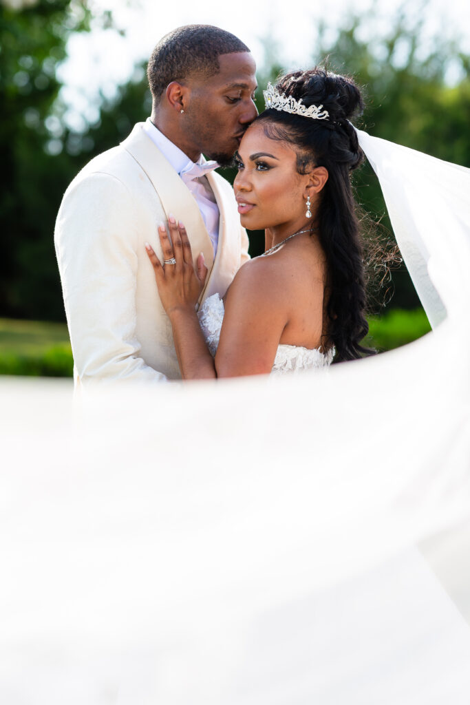 Dallas wedding photographers capture groom kissing bride's forehead
