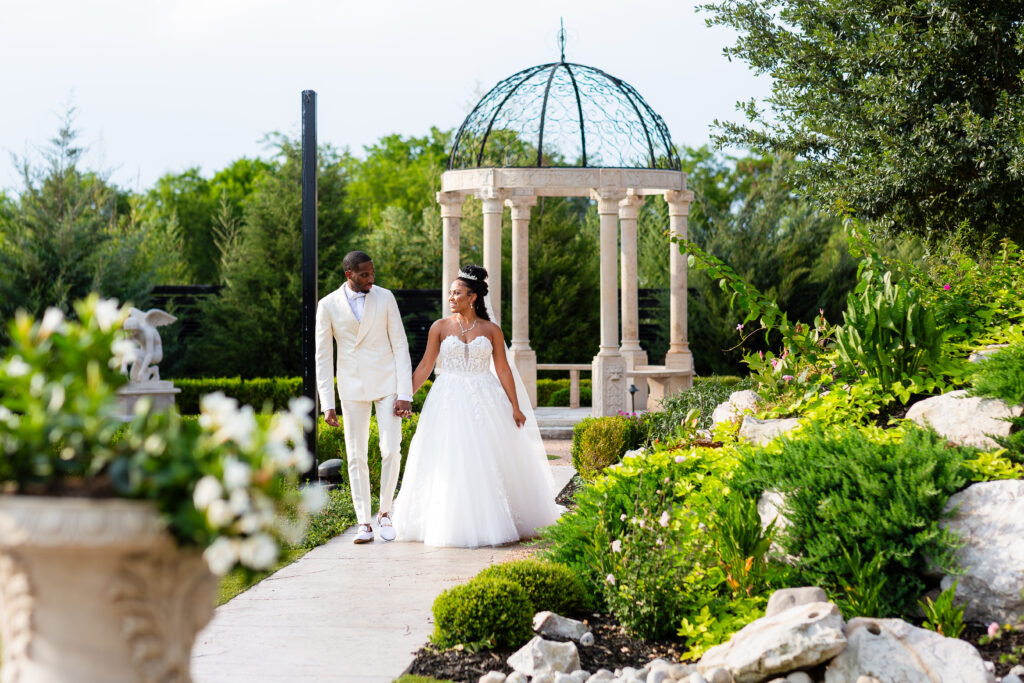 Dallas wedding photographers capture couple walking together at Knotting Hill Place