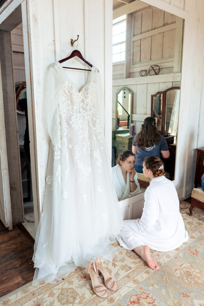 Dallas wedding photographers capture bride sitting on floor while getting ready for wedding day