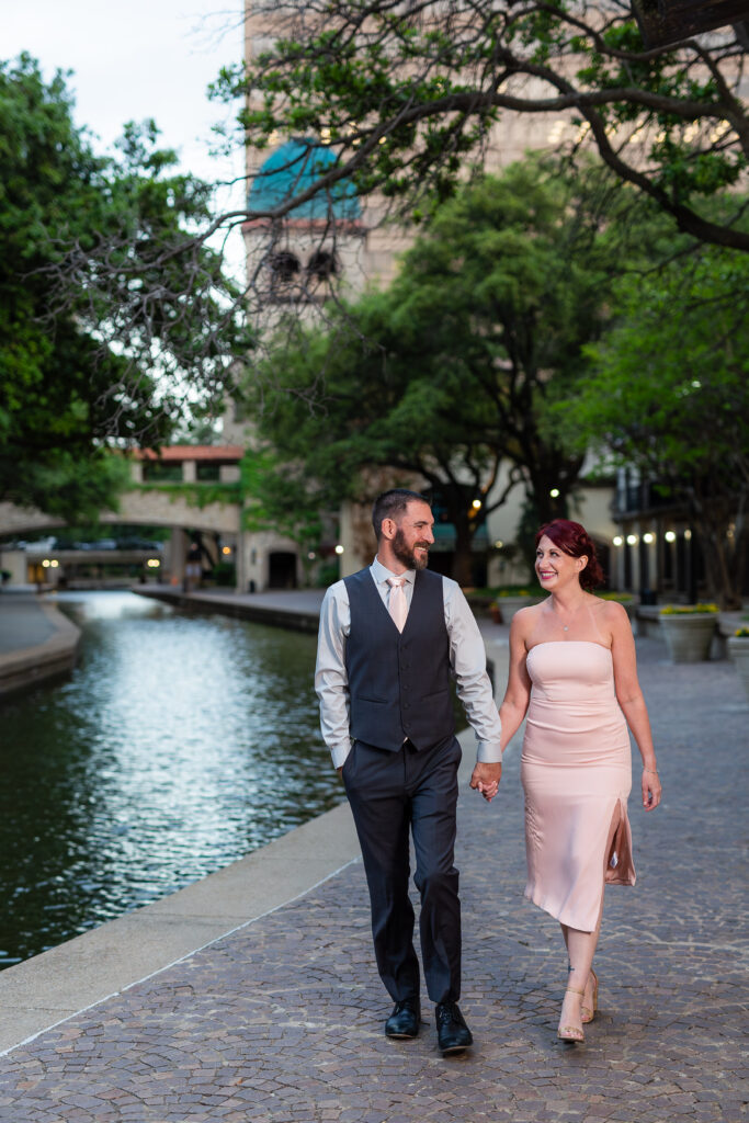 Engagement Photographer Dallas captures couple walking hand in hand along mandalay canal 