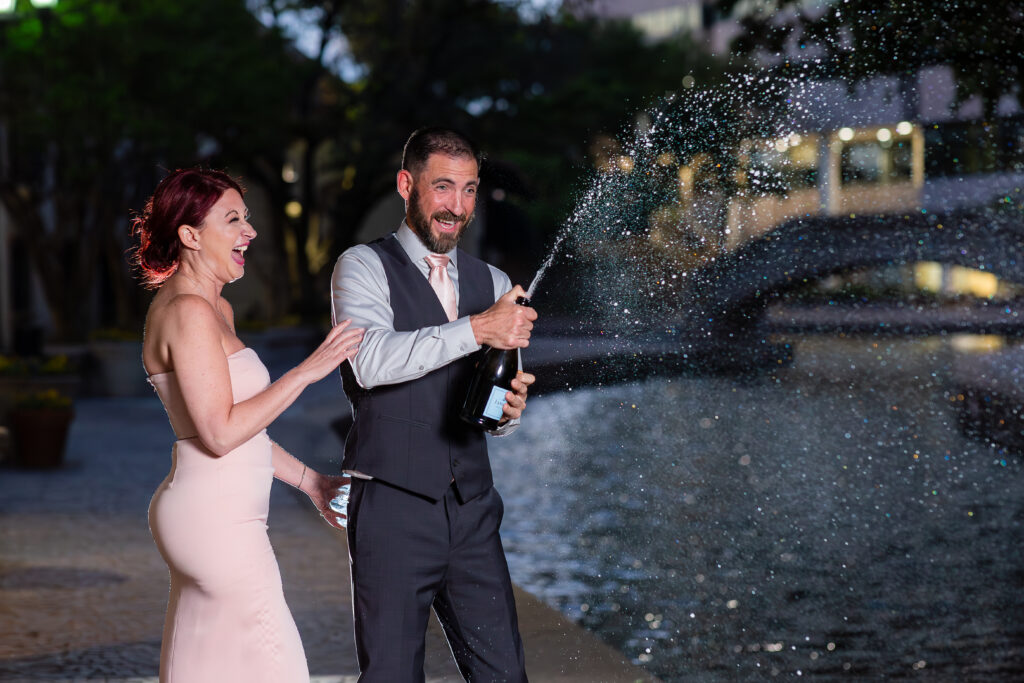 Engagement Photographer Dallas captures couple popping champagne