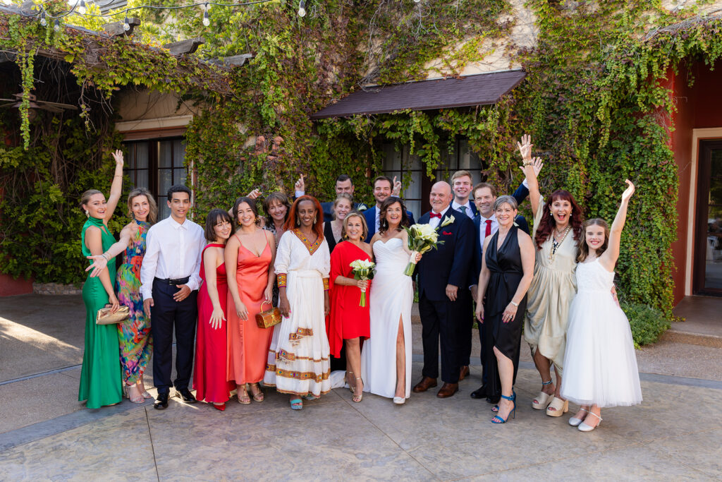 Wedding party celebrating with bride and groom after ceremony in Stoney Ridge Villa's courtyard