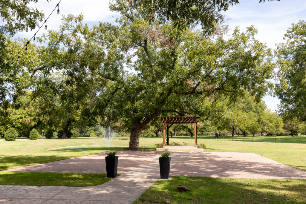 The Orchard Wedding Venue outdoor ceremony site under trees