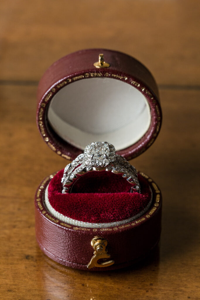 Halo diamond wedding ring set in round red ring box